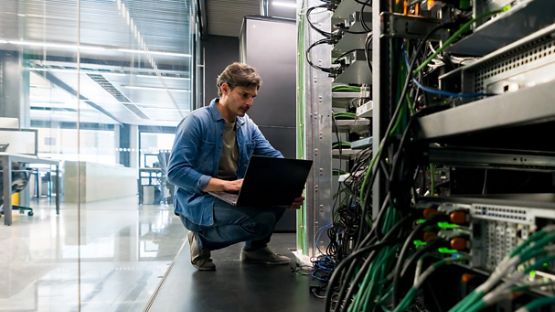 Computer technician fixing a network server at the office