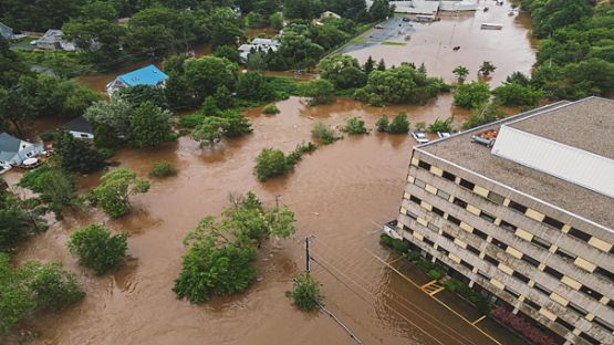 Aerial view of a flooded office building & homes after record breaking rainfall.