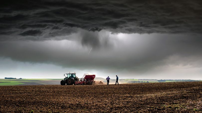 Farmer at work under storm