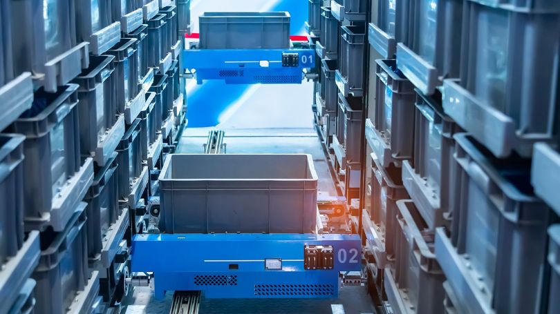 Robotic arm carrying larges shelf at modern distribution warehouse