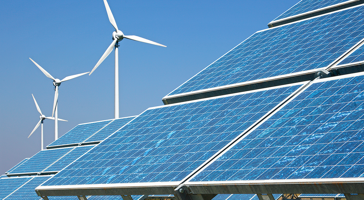 solar panels and wind turbines with blue sky