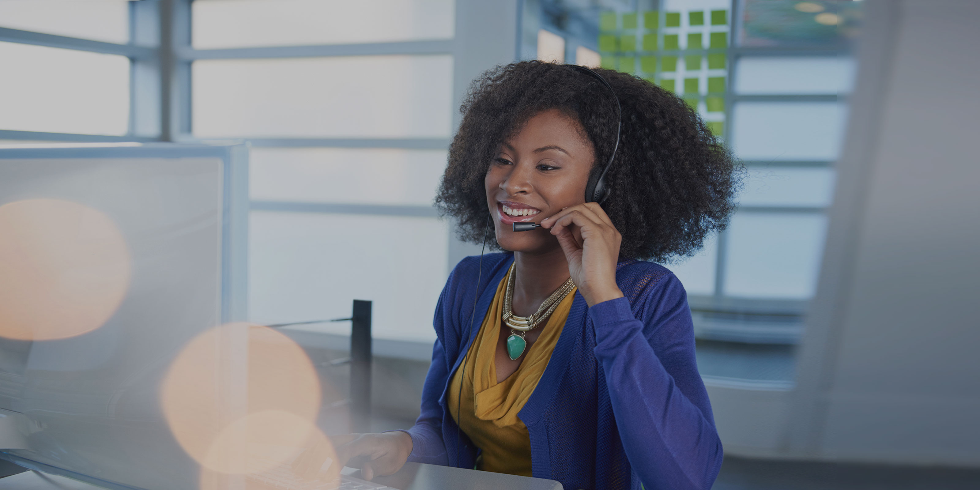 Find a broker background image, person on a headset looking at a computer