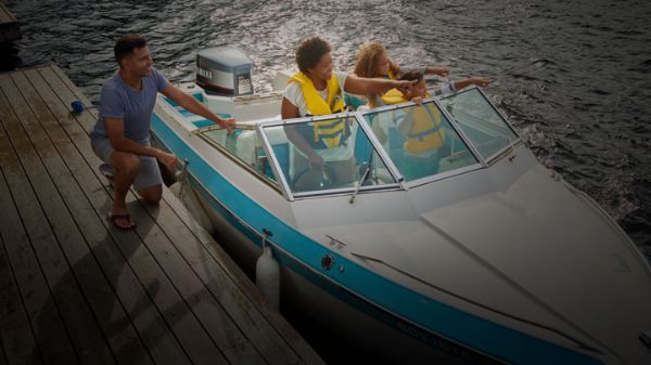 Boat at dock with family in it pointing into distance